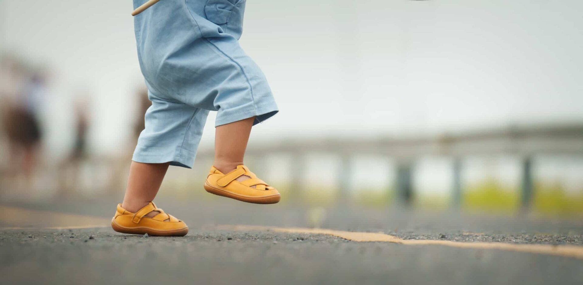 close up leg of infant baby learning to walking first step on pathway. By geargodz - AdobeStock